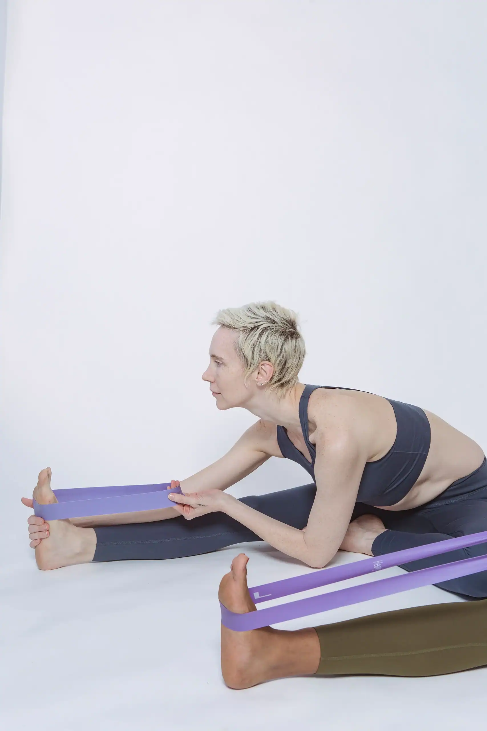 Woman performing a resistance band exercise for added resistance.