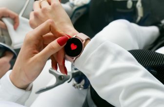 Athlete checking heart rate data on a chest strap monitor during an outdoor running session.