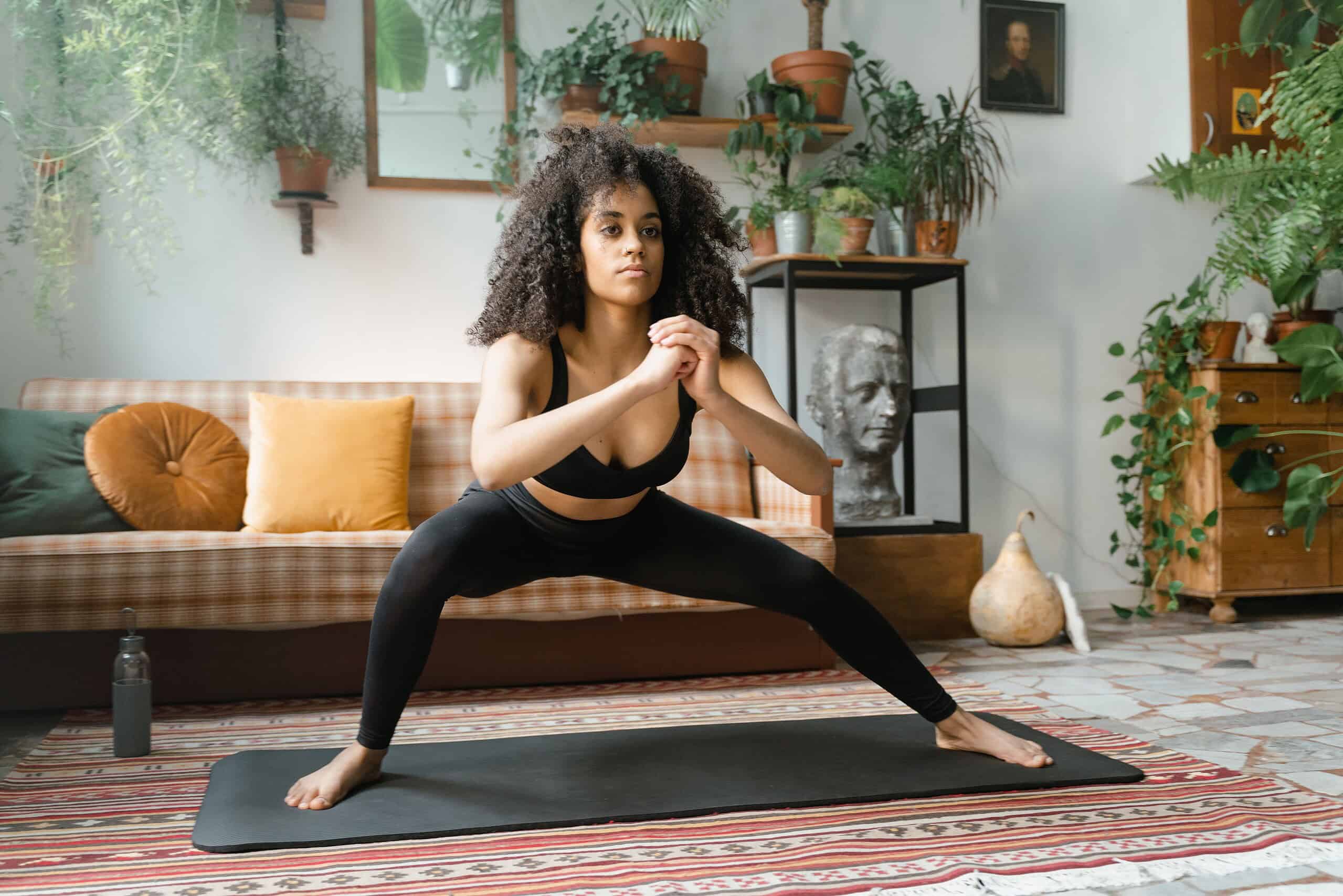 Person performing a exercise on a yoga mat in a bright home workout space.