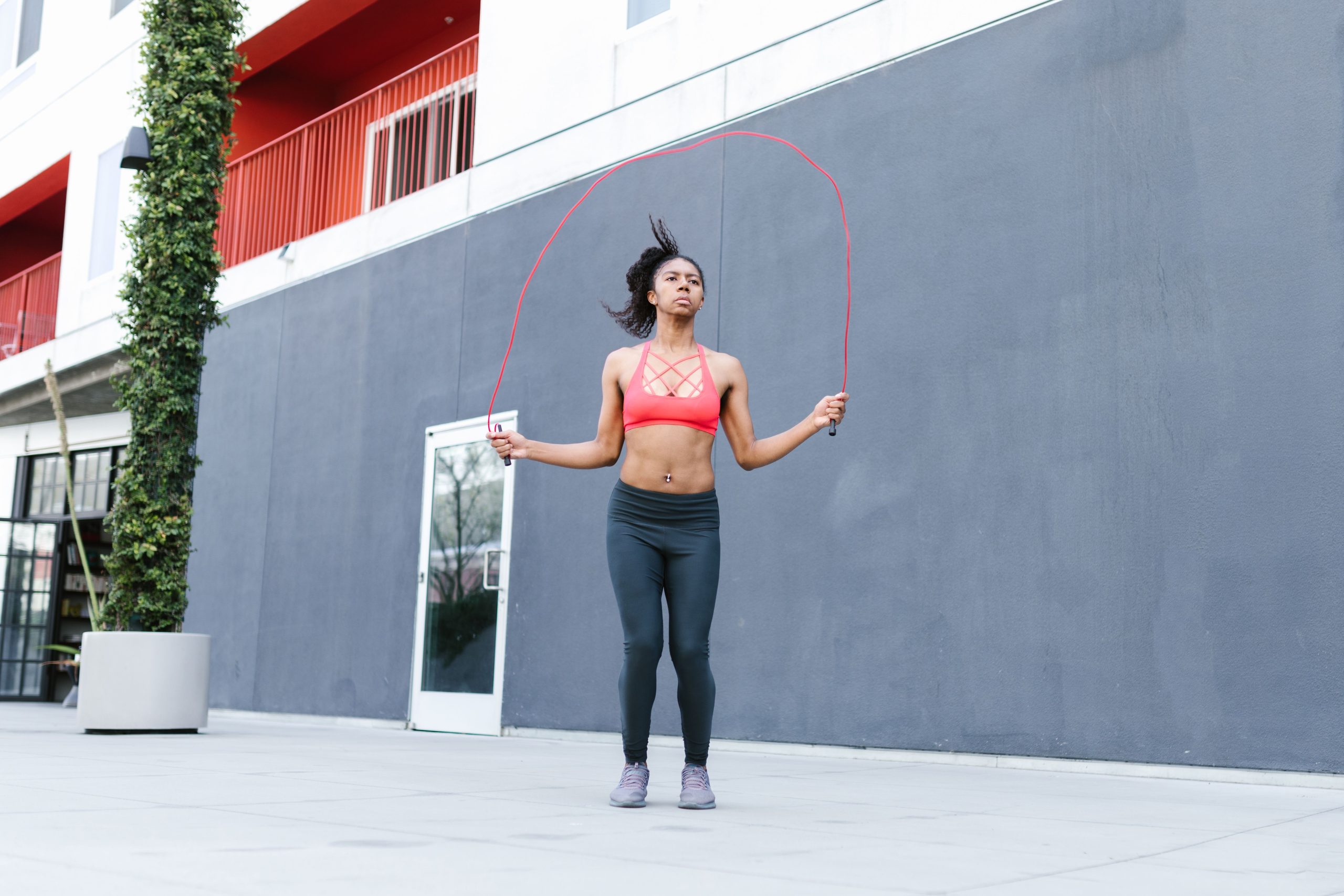 Person jumping rope outdoors during a high-intensity cardio workout session.