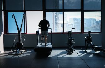 Side by side view of an exercise bike and treadmill in a bright home gym setting.