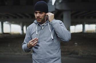 Man wearing an athletic hoodie during an outdoor morning workout session.